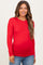 woman wearing a red long sleeve maternity top and showing her baby bump