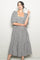 woman wearing a black and white checkered puff sleeve midi dress with a square neckline and tiered skirt