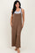 woman wearing a brown sleeveless jumpsuit with wide legs and front pockets