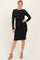 woman wearing a black ribbed two-piece dress with long sleeves and a fitted skirt, paired with tan ankle boots