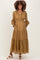 woman wearing a mustard yellow patterned maternity maxi dress with long sleeves and pockets, showcasing her baby bump