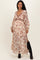 woman wearing a floral long sleeve maternity dress with a v-neckline and side slits, showing her baby bump