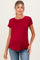 woman wearing a dark red short sleeve maternity top and showing her baby bump