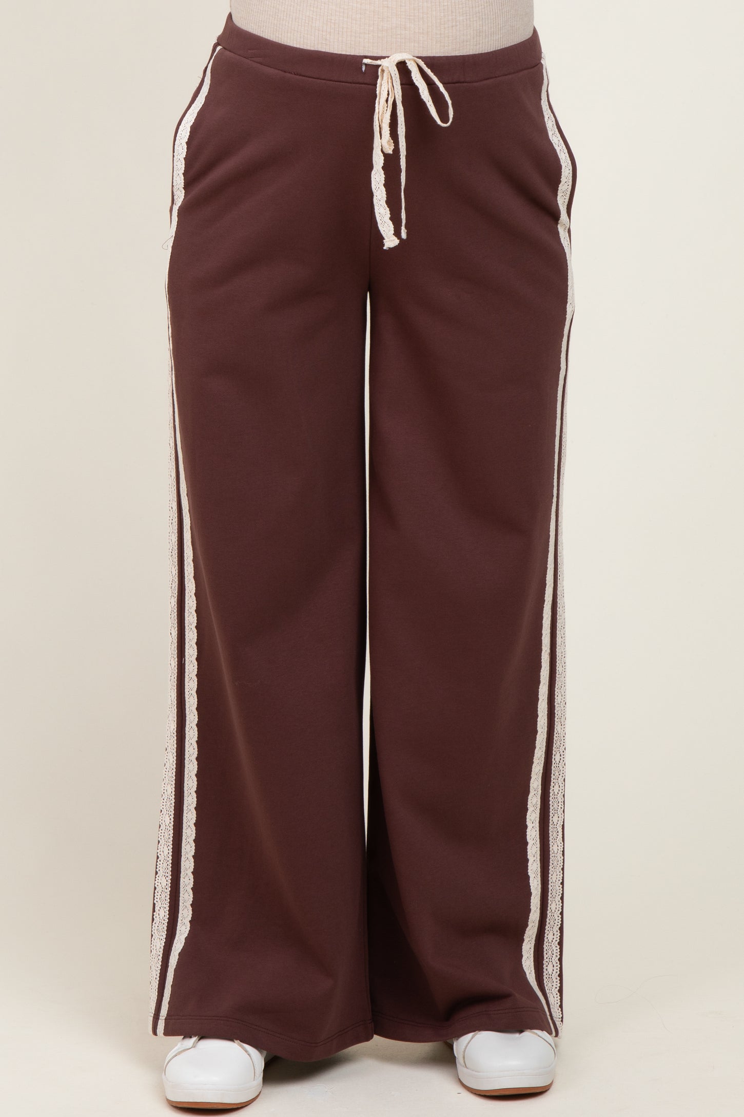 maternity wear in dark brown wide-leg pants with lace detailing and an elastic drawstring waistband