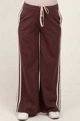 maternity wear in dark brown wide-leg pants with lace detailing and an elastic drawstring waistband