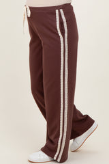 woman wearing burgundy maternity sweatpants with lace side details and drawstring waist