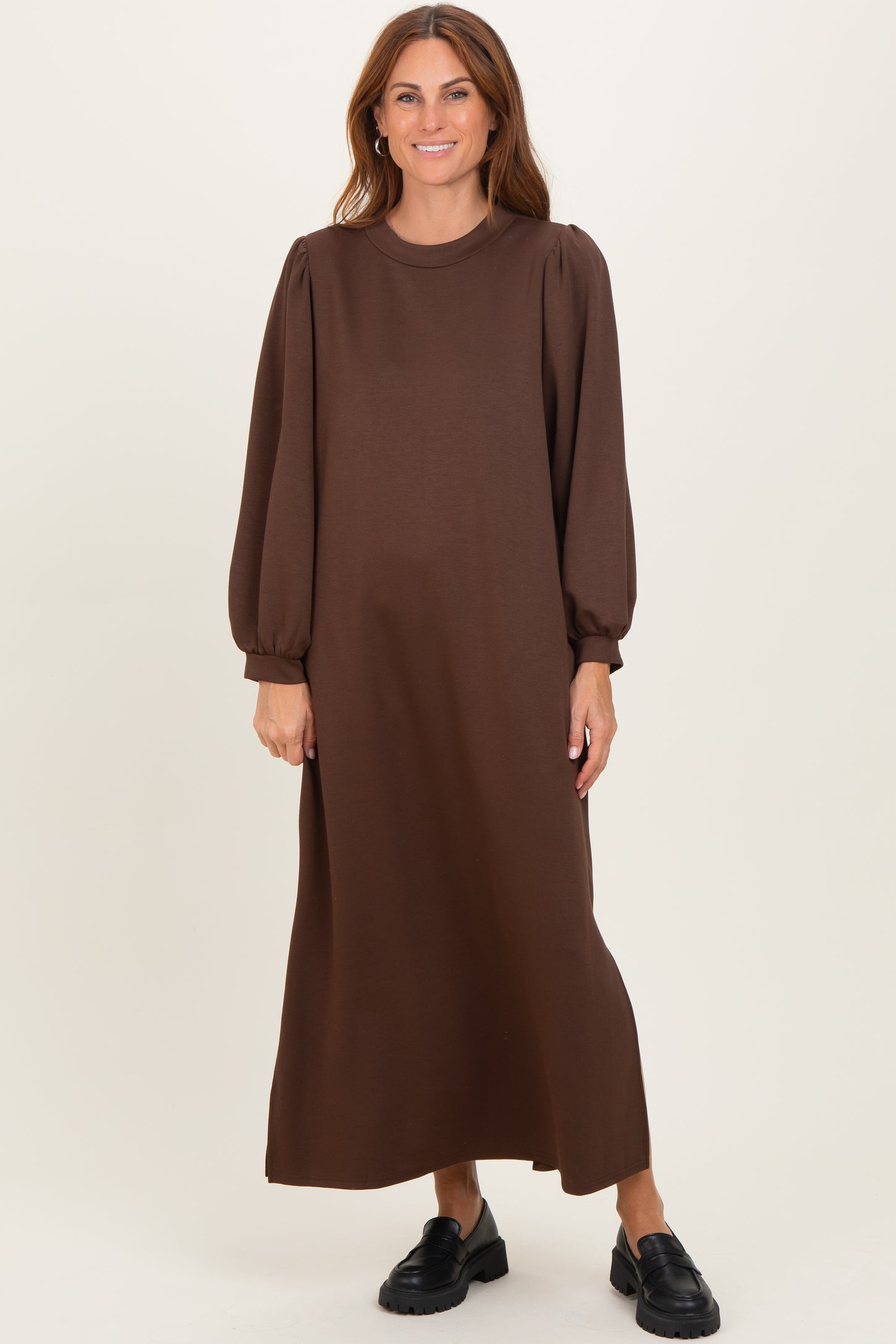 woman wearing a brown long sleeve maxi dress with puff sleeves and a relaxed fit