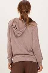 woman wearing a taupe ribbed hooded sweatshirt with a relaxed fit and long sleeves, viewed from the back