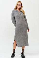 woman wearing a gray ribbed long sleeve midi dress with side slits and a lace-up neckline