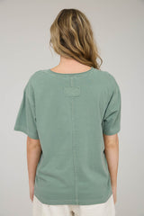 woman wearing a green oversized t-shirt with a relaxed fit and back stitch detail