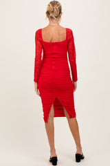 woman wearing a red long sleeve ruched maternity dress with lace sleeves and a back slit