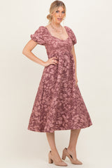 woman wearing a burgundy floral midi dress with puff sleeves and a square neckline paired with beige high heel shoes