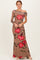 woman wearing a brown off-shoulder maxi dress with red floral print and a fitted silhouette