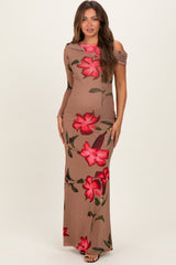 woman wearing a beige maternity dress with large red floral print and one shoulder design