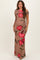 woman wearing a beige maternity dress with large red floral print and one shoulder design