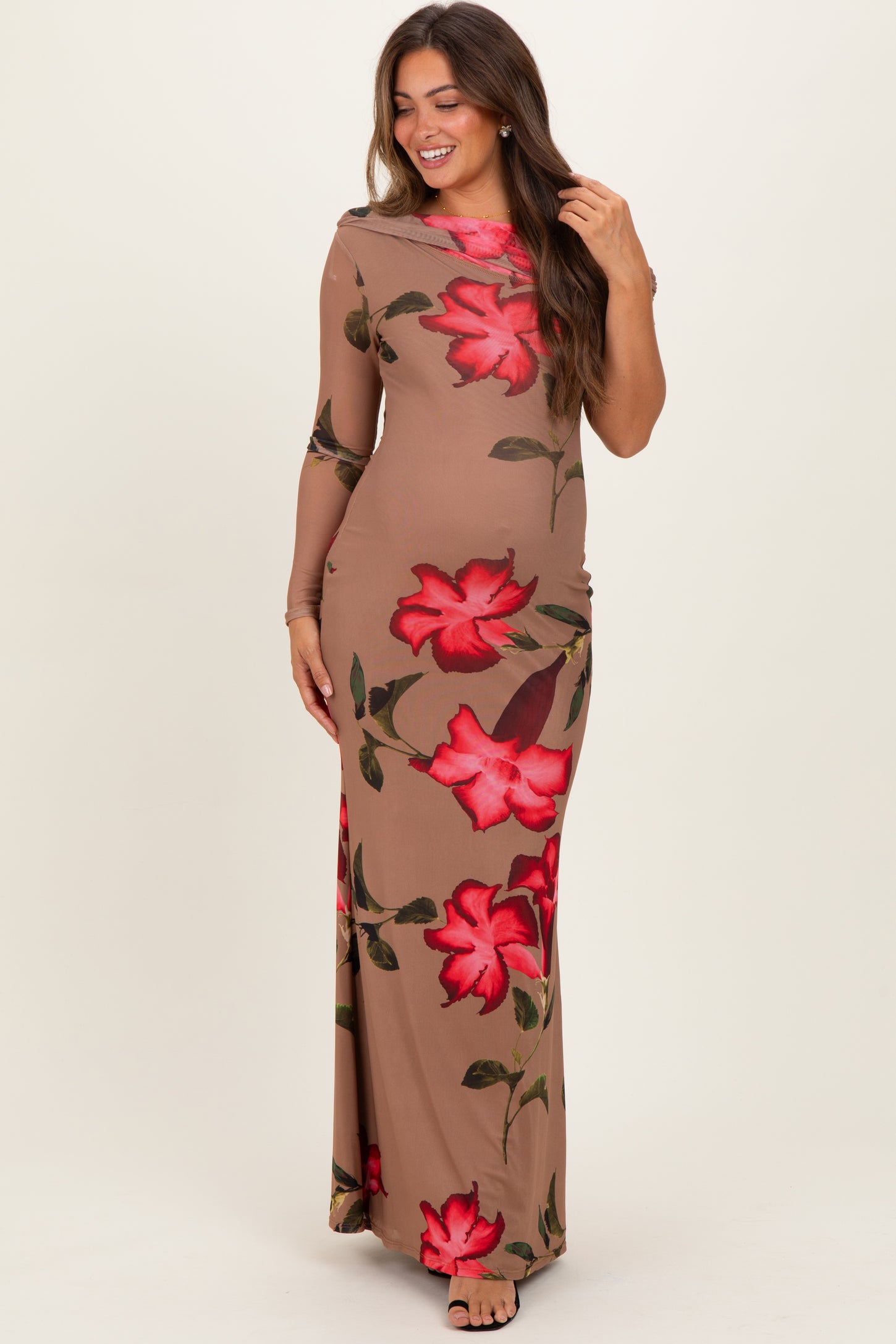 woman wearing a long sleeve beige floral maternity dress with red roses and a fitted silhouette