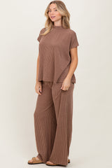 woman wearing a brown ribbed lounge set with a short sleeve top and wide-leg pants