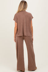 woman wearing a brown ribbed maternity top and matching wide-leg pants, showing a relaxed fit from the back