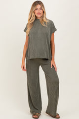 woman wearing a green ribbed maternity lounge set with a short sleeve top and wide-leg pants