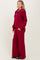 woman wearing a burgundy zip-up pullover and matching wide-leg pants