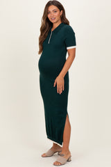 woman wearing a dark green maternity dress with a collar and side slit, showing her baby bump