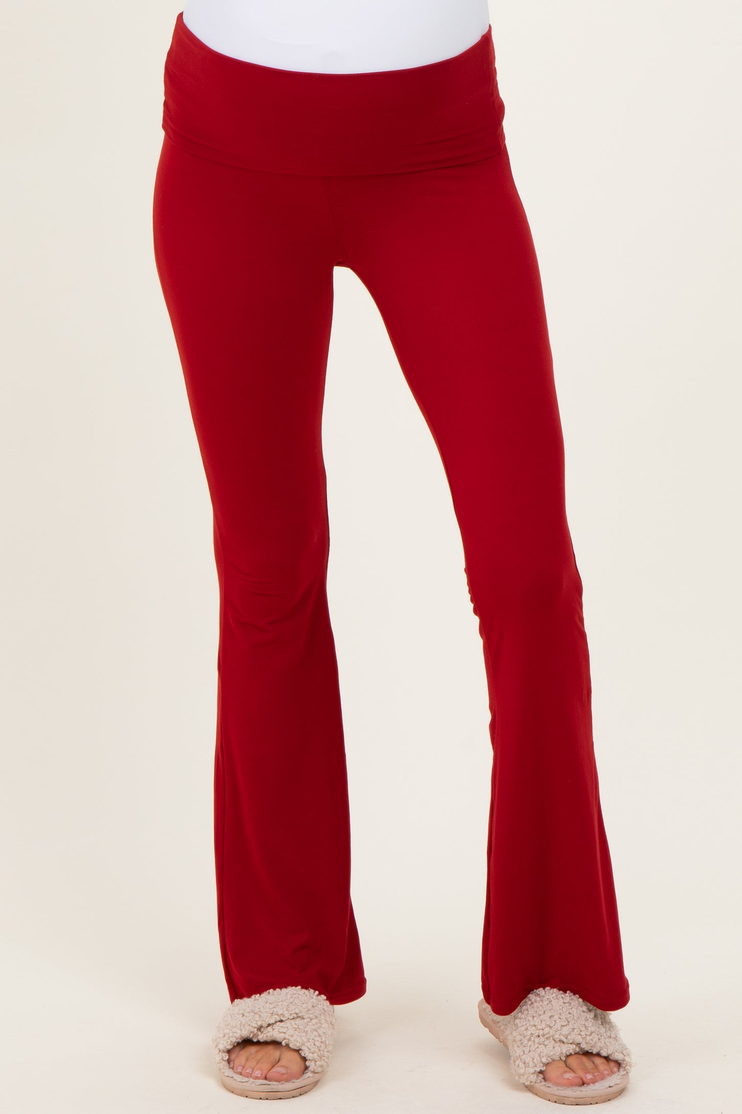 woman wearing red maternity flare pants with a comfy waistband