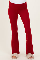 woman wearing red maternity flare pants with a comfy waistband