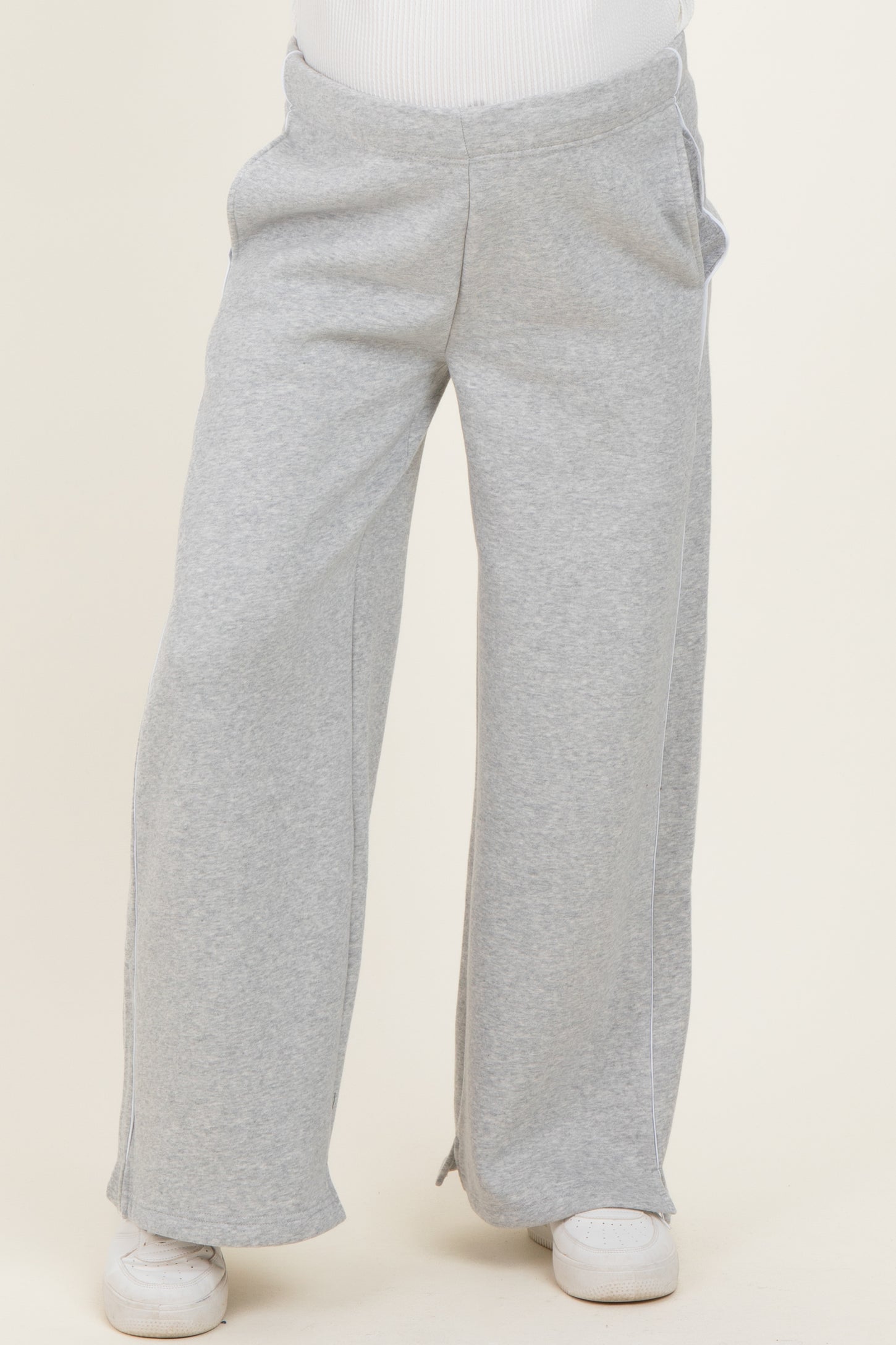 woman wearing gray maternity sweatpants with a relaxed fit and side pockets