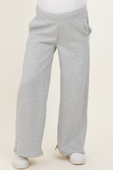 woman wearing gray maternity sweatpants with a relaxed fit and side pockets