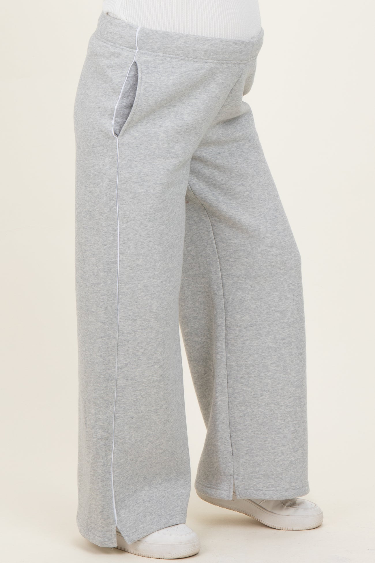 woman wearing gray maternity sweatpants with side pockets and a relaxed fit
