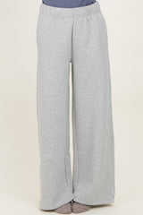 woman wearing light gray wide-leg sweatpants with an elastic waistband