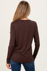 woman wearing a chocolate brown long sleeve maternity top, showing the back view with a relaxed fit
