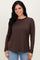 woman wearing a brown long sleeve top paired with light blue jeans