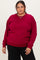 woman wearing a burgundy oversized sweatshirt with drop shoulder seams and relaxed fit