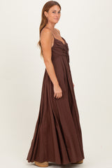 woman wearing a dark brown maxi dress with a ruched bodice and adjustable straps