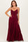 woman wearing a burgundy maxi dress with adjustable straps and a tie front detail