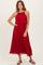 woman wearing a red pleated midi dress with a halter neckline and flowy skirt, styled with black sandals