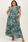 woman wearing a green floral print plus size maxi dress with ruffled sleeves and a deep v-neckline