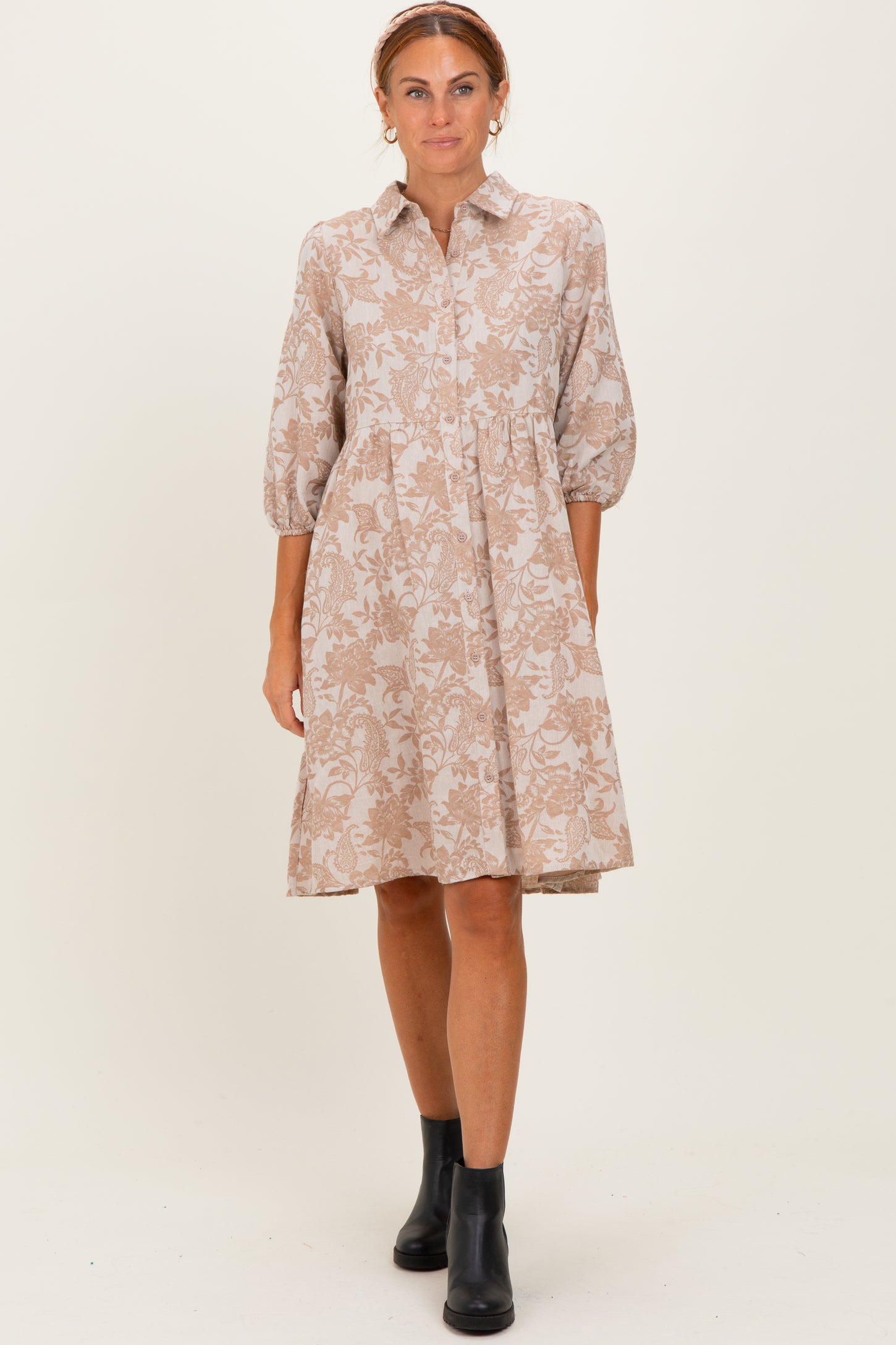 woman wearing a beige floral print shirt dress with balloon sleeves and a flared skirt
