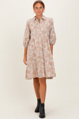woman wearing a beige floral print shirt dress with balloon sleeves and a flared skirt