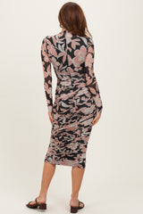 woman wearing a floral print long sleeve bodycon dress with ruching, viewed from the back