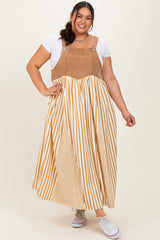 woman wearing a plus size striped maxi dress with a tan and white color scheme and denim-style top portion