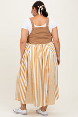 woman wearing a plus size tan and white striped dress with a fitted bodice and a flowing skirt, viewed from the back