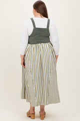 woman wearing a green and white striped maternity plus dress with a fitted bodice and flowing skirt, showing her back
