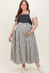 woman wearing a black and white striped maternity dress with denim top, showing her baby bump