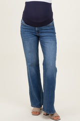 woman wearing navy blue maternity jeans with a supportive belly panel and light wash flared legs