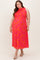 woman wearing a bright pink floral maxi maternity dress with sleeveless design and a fitted bodice