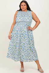 woman wearing a sleeveless plus-size maxi dress with a floral print in blue and green shades