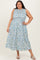 woman wearing a sleeveless plus-size maxi dress with a floral print in blue and green shades