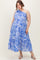 woman wearing a blue and white floral one-shoulder maternity plus dress with a tiered skirt and a flowing silhouette